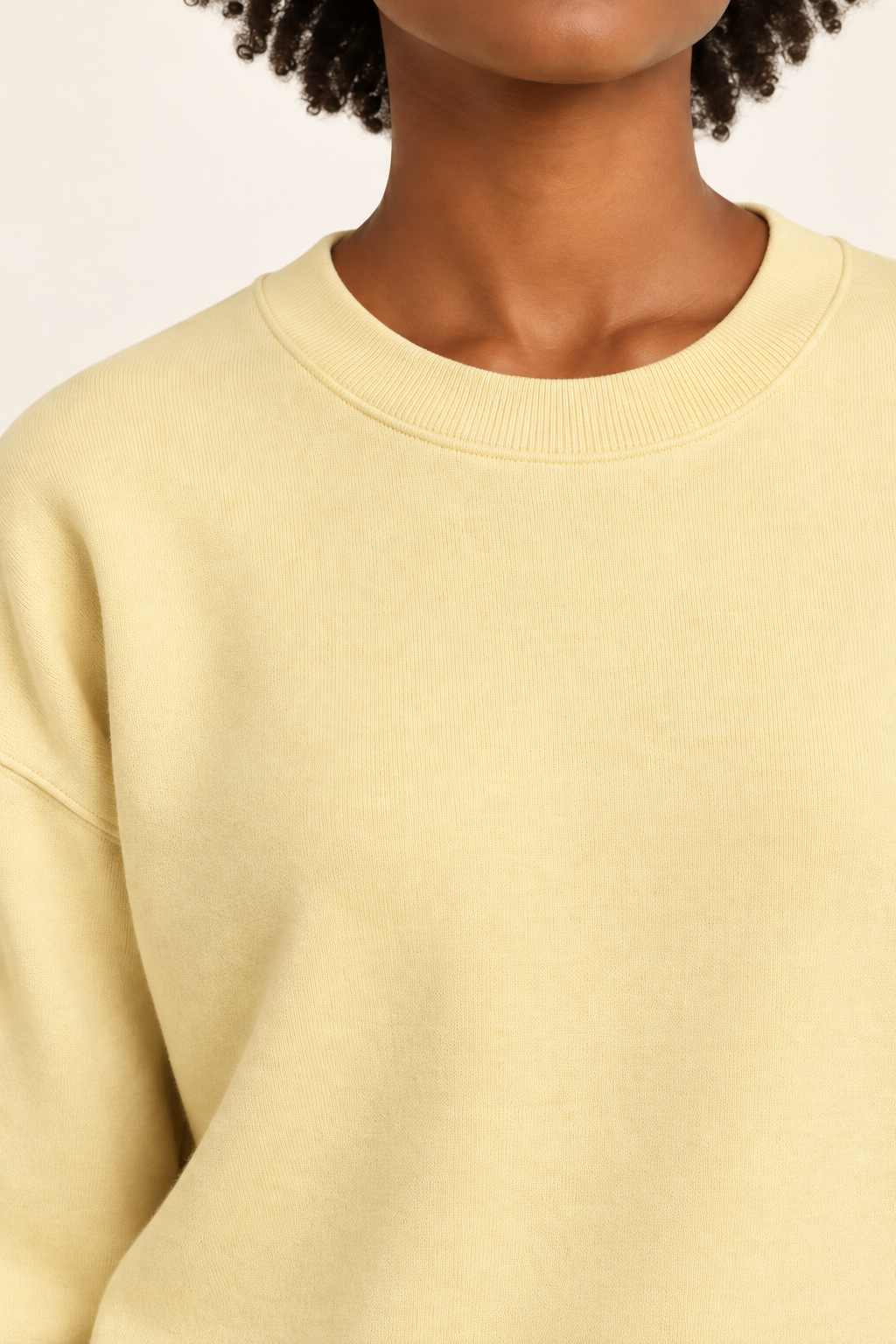 Soft Pause Relaxed Crewneck in Mellow. Close-up showing the fine Mellow knit and ribbed crew neckline.