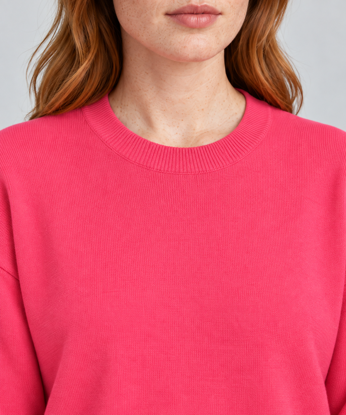 Soft Pause Relaxed Crewneck in Hot Pink. Close-up showing the fine Hot Pink knit and ribbed crew neckline.