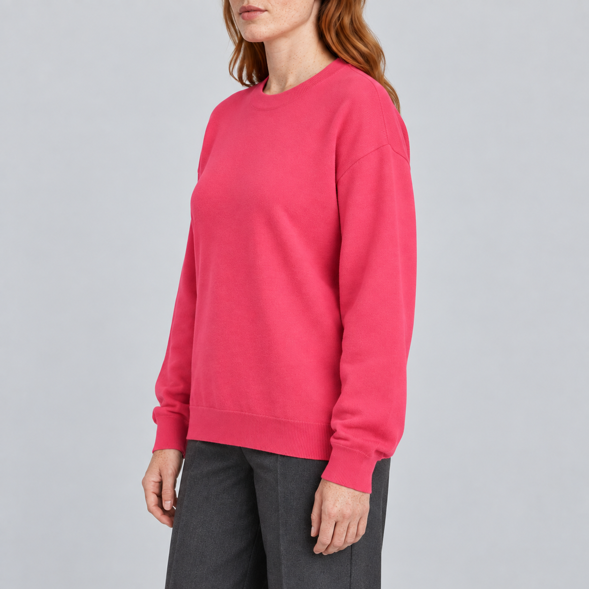 Soft Pause Relaxed Crewneck in Hot Pink. Side view showing the relaxed Hot Pink silhouette.
