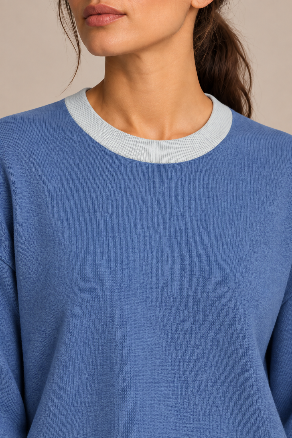 Soft Pause Relaxed Crewneck in Denim with Powder Trim. Close-up showing the fine Denim knit and Powder ribbed crew neckline.