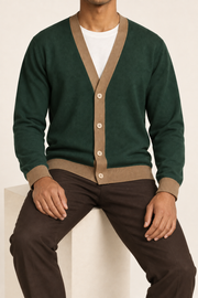 After Hours Cardigan in Pine with Peanut Trim. Seated studio view showing the natural drape and button front.