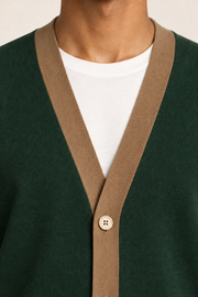 After Hours Cardigan in Pine with Peanut Trim. Close-up showing the fine knit, contrasting V-neck trim and upper button.