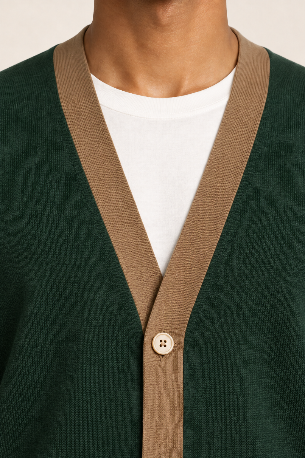 After Hours Cardigan in Pine with Peanut Trim. Close-up showing the fine knit, contrasting V-neck trim and upper button.