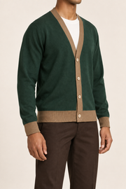 After Hours Cardigan in Pine with Peanut Trim. Three-quarter studio view showing the sleeve shape and contrast edging.