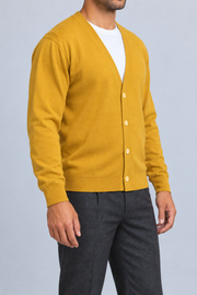 After Hours Cardigan in Mustard. Three-quarter studio view showing the side silhouette and button front.