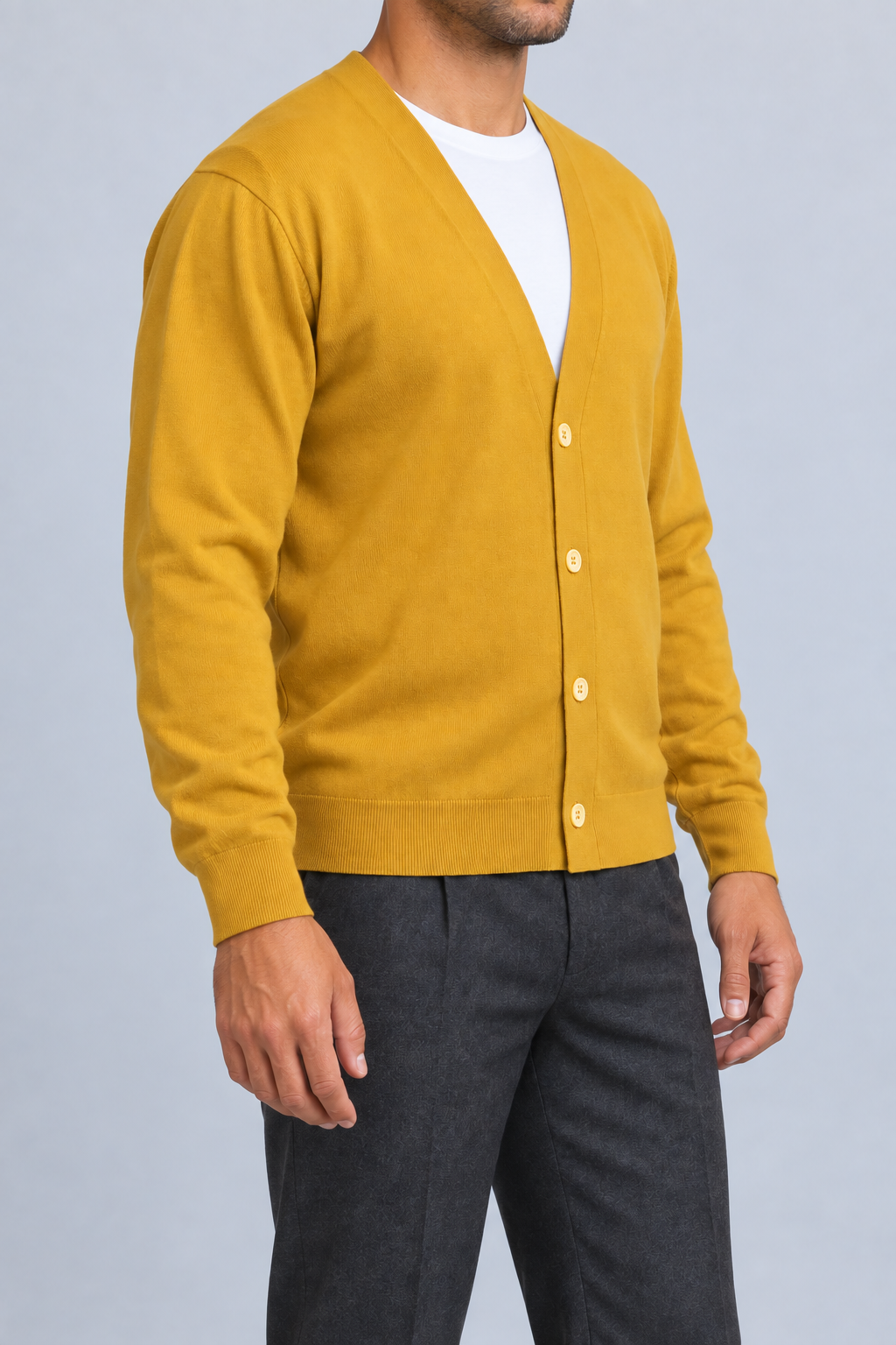 After Hours Cardigan in Mustard. Three-quarter studio view showing the side silhouette and button front.