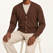 After Hours Cardigan in Soil. Seated studio view showing the long sleeves and natural knit drape.