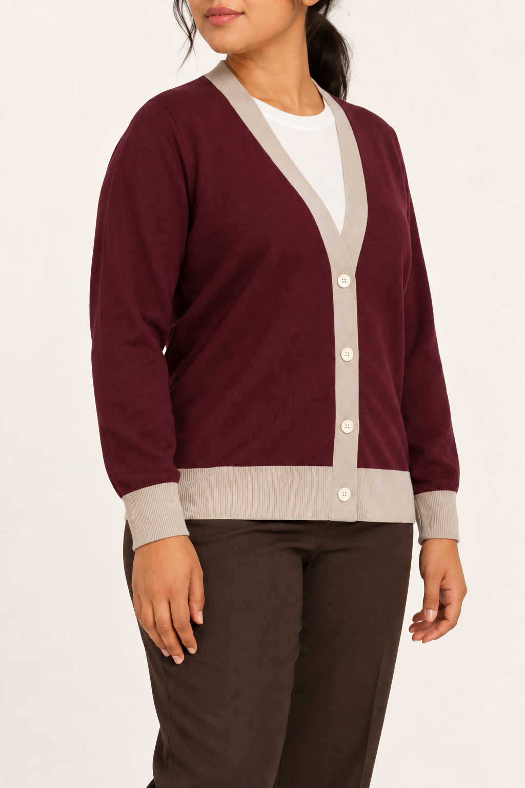 Soft Interval Cardigan in Burgundy with Coco Trim. Three-quarter studio view showing the side silhouette and contrast button front.