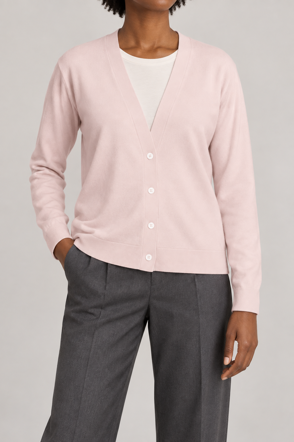 Soft Interval Cardigan in Lt Pink. Front studio view showing the plain knit and four-button V-neck front.