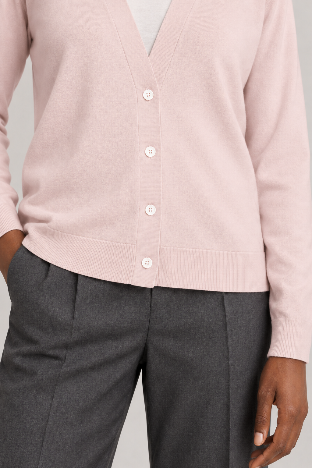 Soft Interval Cardigan in Lt Pink. Close-up showing the white buttons, fine knit and ribbed hem and cuff.