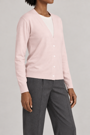 Soft Interval Cardigan in Lt Pink. Three-quarter studio view showing the side silhouette and button front.