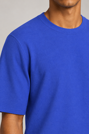 Close-up detail of Open Hours Knit T-Shirt in Royal, showing blue knit texture and crewneck edge.