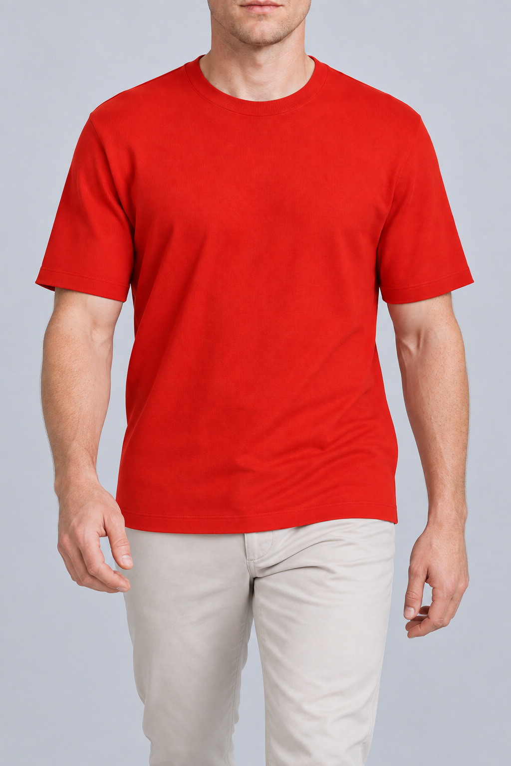 Walking studio view of Open Hours Knit T-Shirt in Chili, showing red knit drape above pale trousers.