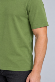 Close-up detail of Open Hours Knit T-Shirt in Grass, showing green knit texture and short sleeve edge.
