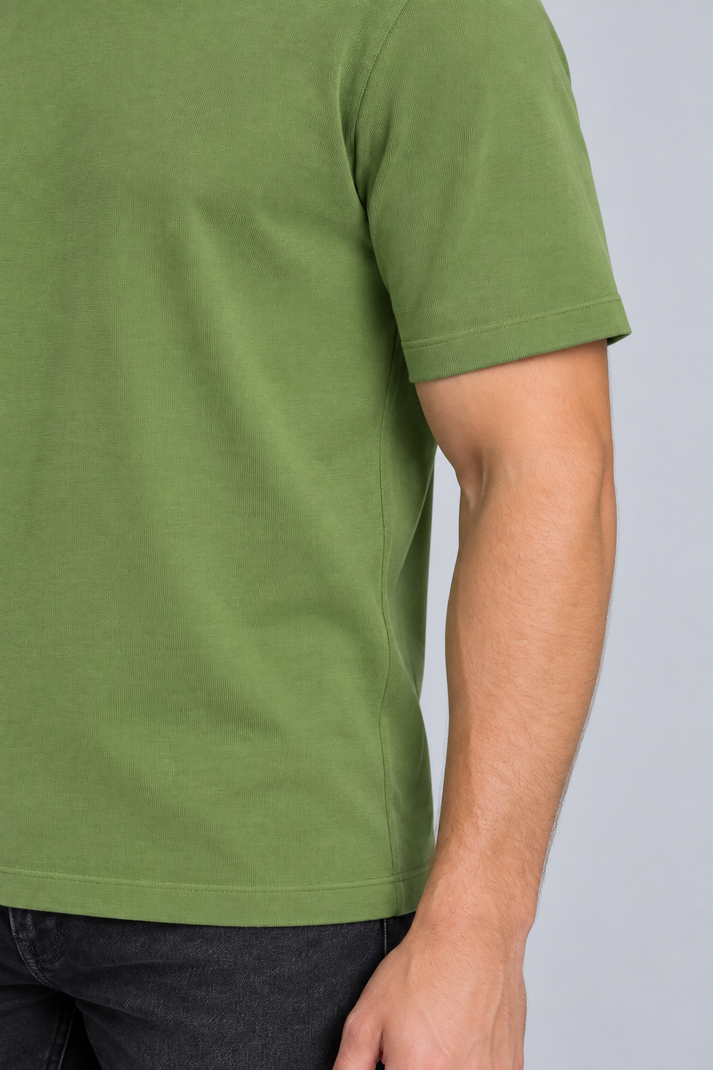 Close-up detail of Open Hours Knit T-Shirt in Grass, showing green knit texture and short sleeve edge.