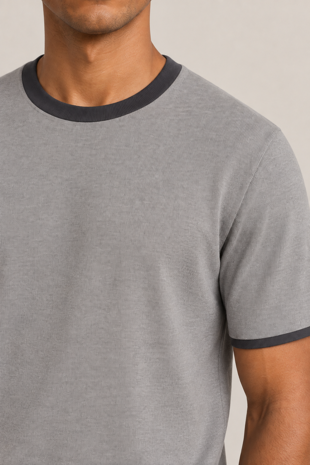 Close-up detail of Open Hours Knit T-Shirt in Grey with Charcoal Trim, showing grey knit texture and charcoal neck band.