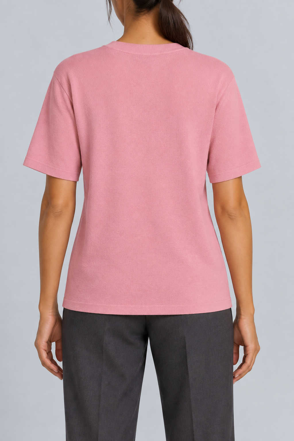 Rear studio view of Soft Tempo Knit T-Shirt in Pink, showing plain pink back and short sleeves.