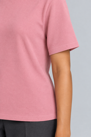 Close-up detail of Soft Tempo Knit T-Shirt in Pink, showing pink knit texture and short sleeve edge.