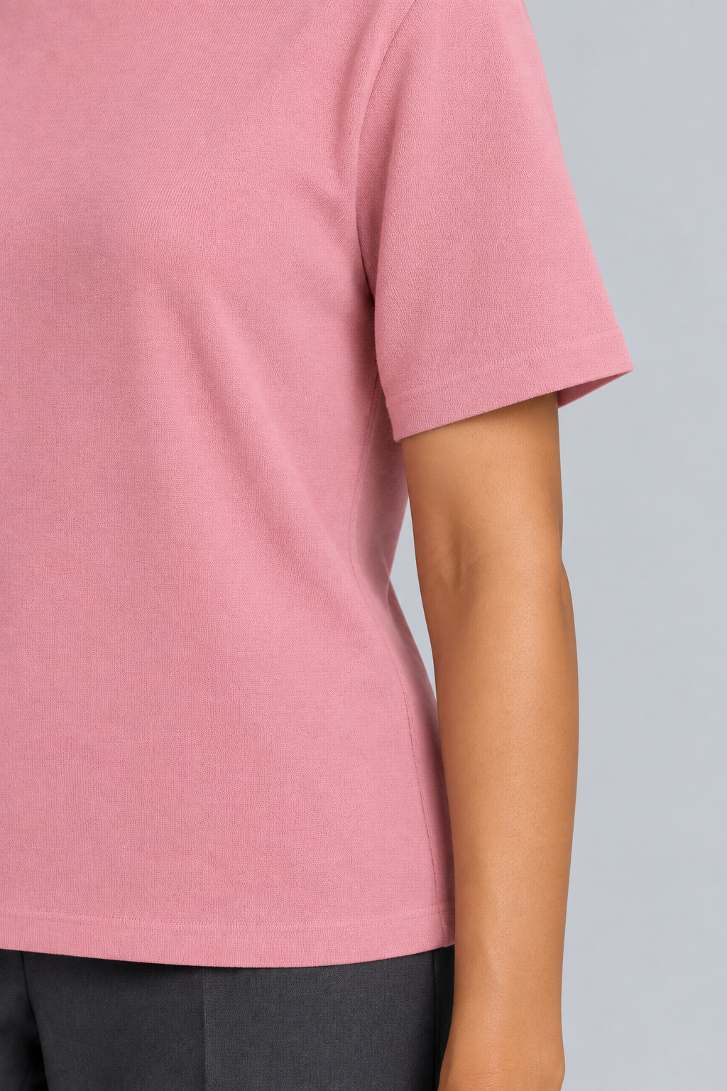 Close-up detail of Soft Tempo Knit T-Shirt in Pink, showing pink knit texture and short sleeve edge.