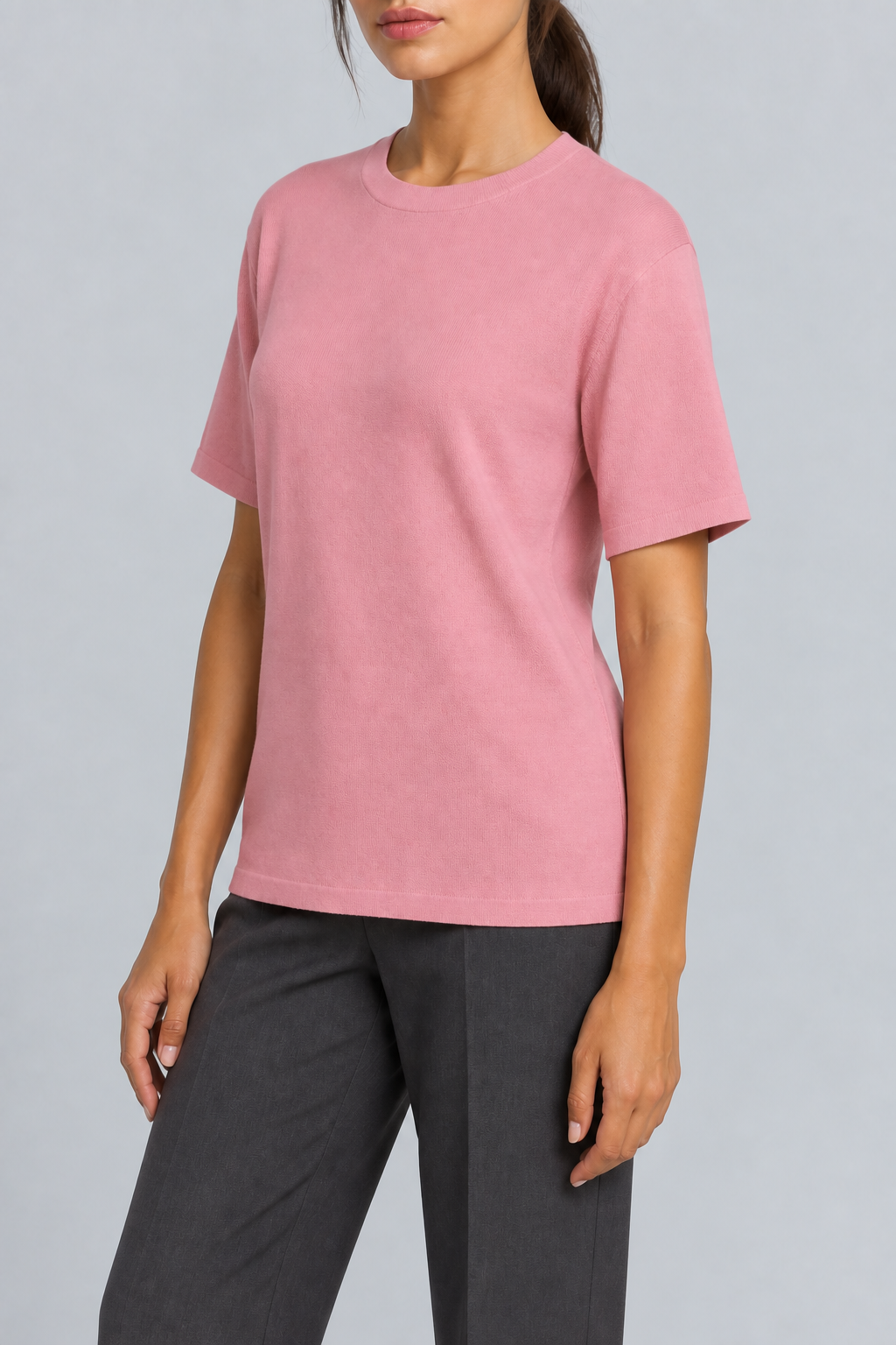 Three-quarter studio view of Soft Tempo Knit T-Shirt in Pink, showing short sleeves and clean pink silhouette.