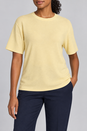 Front studio view of Soft Tempo Knit T-Shirt in Mellow, showing plain pale yellow knit and crew neckline.