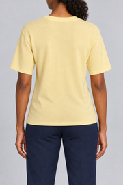 Rear studio view of Soft Tempo Knit T-Shirt in Mellow, showing plain yellow back and short sleeves.
