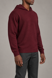 Three-quarter view showing the relaxed silhouette and matching edges of Off Hours Knit Hoodie in Burgundy.