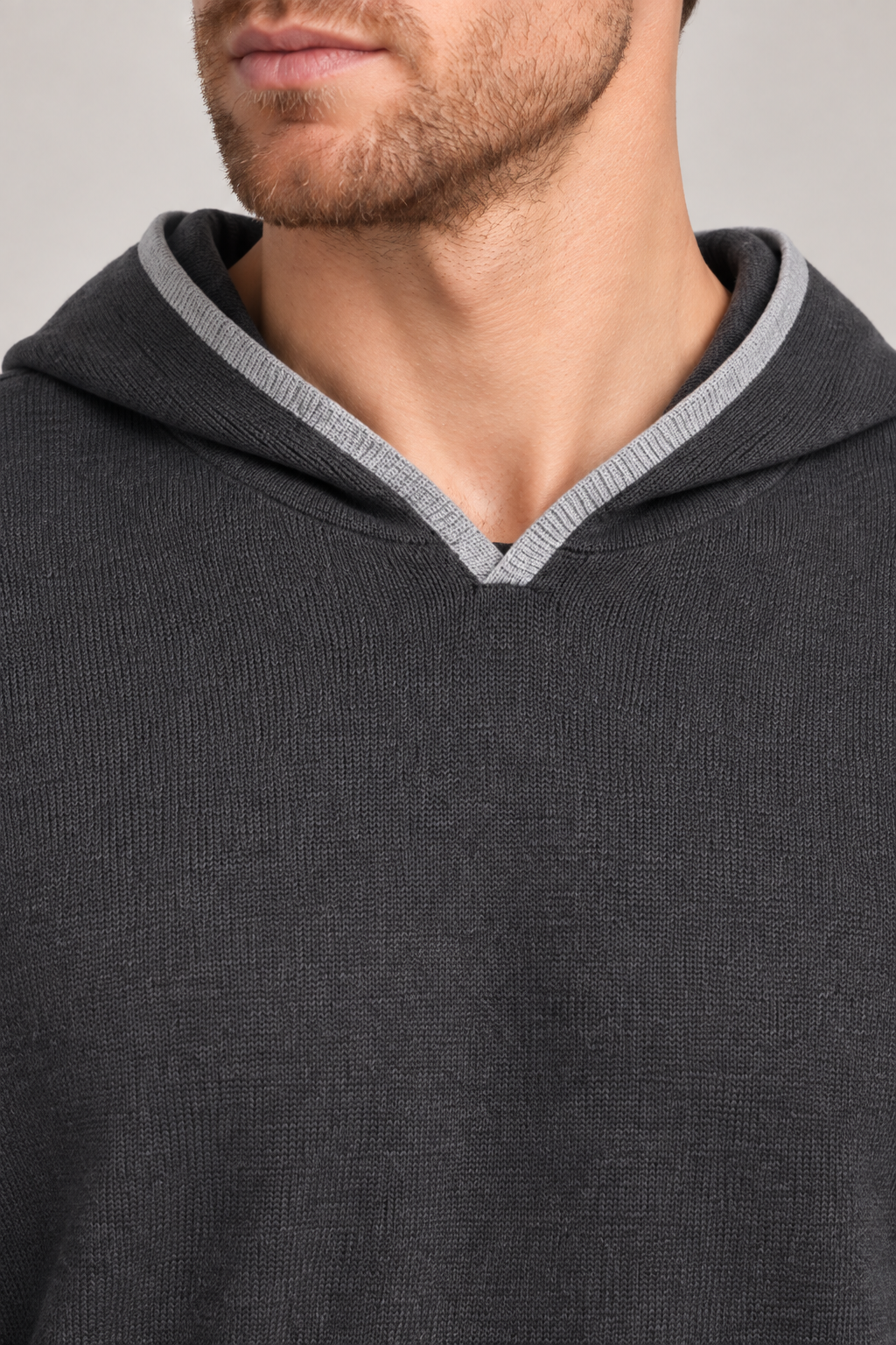 Detail view of the hood opening and Grey edging of Off Hours Knit Hoodie in Charcoal with Grey Trim.