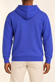 Rear view showing the plain blue back and draped hood of Off Hours Knit Hoodie in Royal.