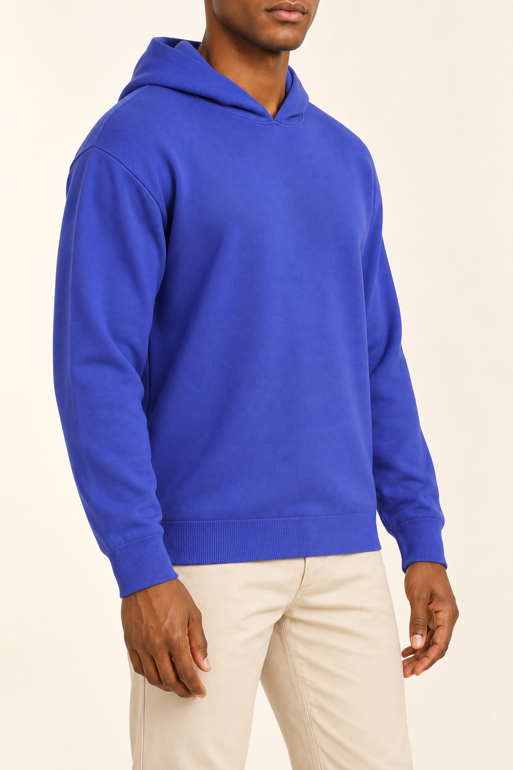 Three-quarter view showing the relaxed silhouette and matching edges of Off Hours Knit Hoodie in Royal.