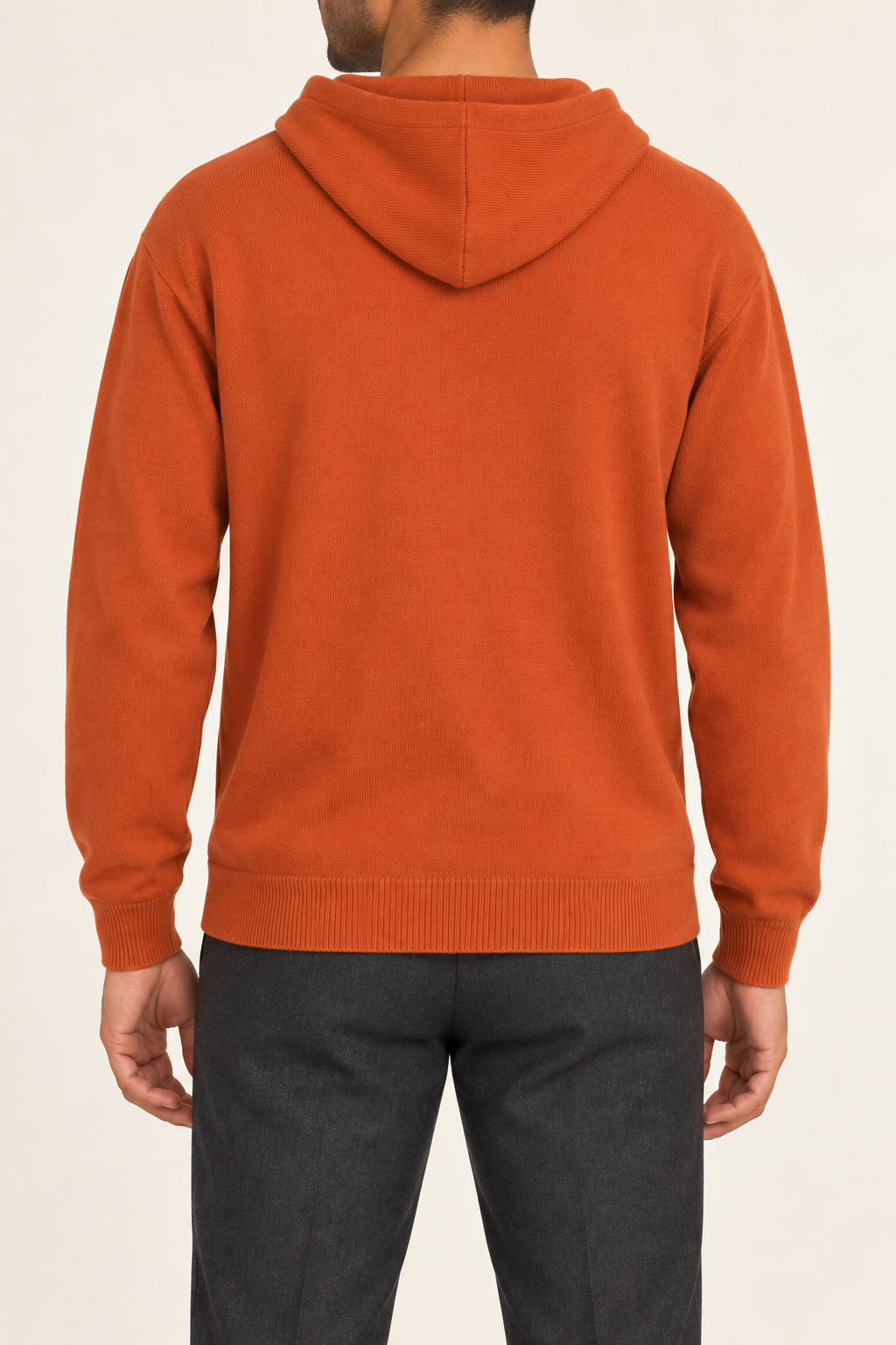 Rear view showing the plain orange back and draped hood of Off Hours Knit Hoodie in Burnt Orange.