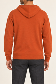 Rear view showing the plain orange back and draped hood of Off Hours Knit Hoodie in Burnt Orange.