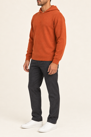 Three-quarter view showing the relaxed silhouette and matching edges of Off Hours Knit Hoodie in Burnt Orange.