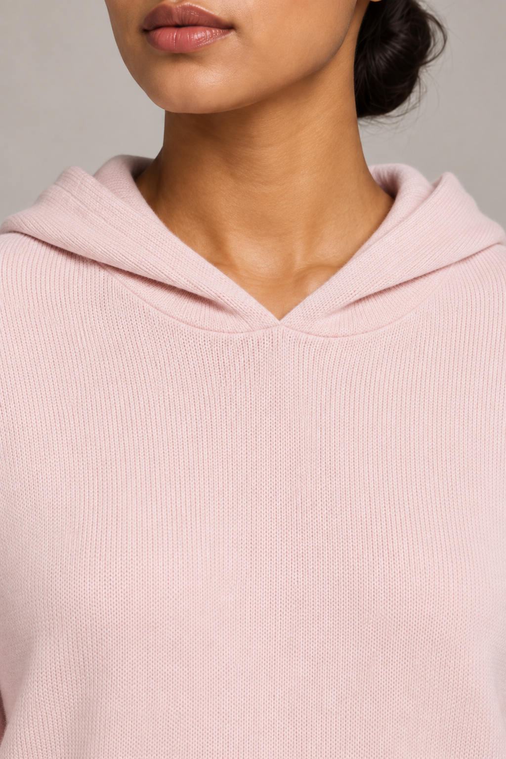 Detail view of the hood neckline and Lt Pink knit texture of Quiet Ease Knit Hoodie in Lt Pink.