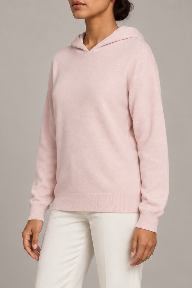 Three-quarter view showing the relaxed silhouette and matching edges of Quiet Ease Knit Hoodie in Lt Pink.