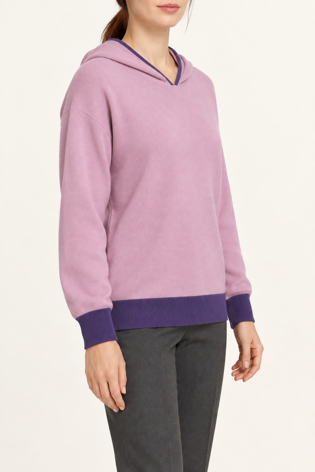 Three-quarter view showing the relaxed silhouette and contrasting cuffs of Quiet Ease Knit Hoodie in Lilac with Violet Trim.