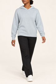 Walking view showing the soft knit drape and long sleeves of Quiet Ease Knit Hoodie in Powder.