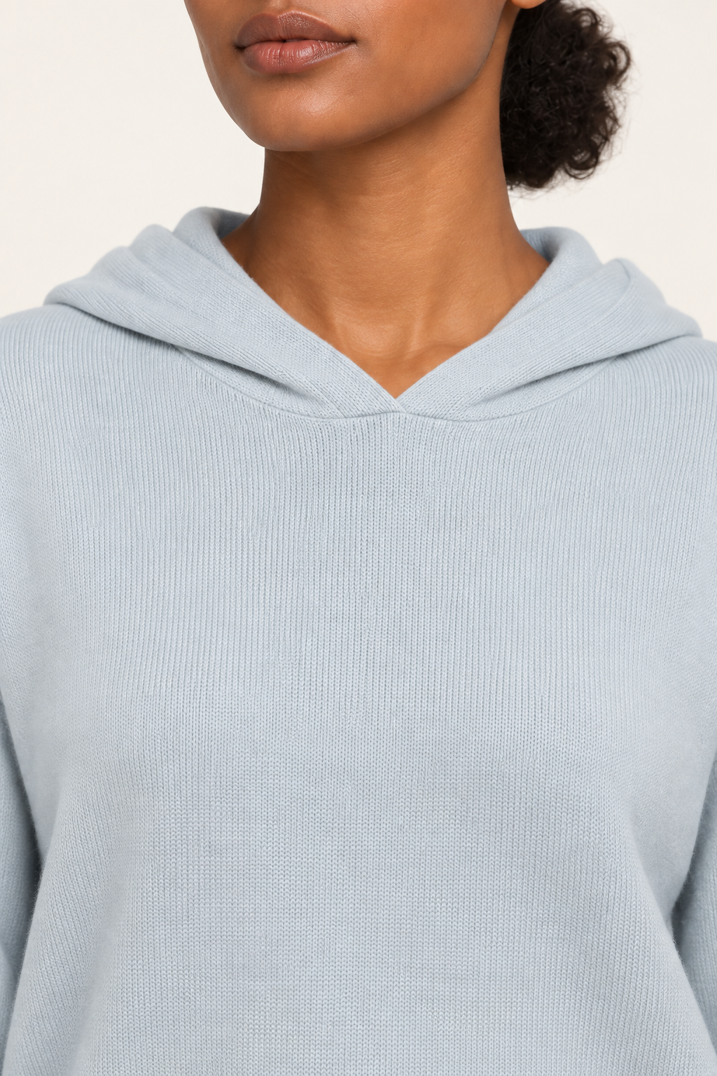 Detail view of the hood neckline and Powder knit texture of Quiet Ease Knit Hoodie in Powder.