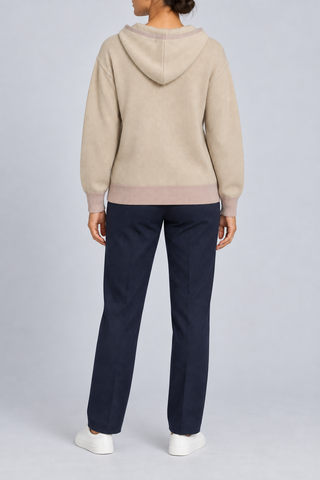 Rear view showing the plain back and contrasting Taupe hem of Quiet Ease Knit Hoodie in Beige with Taupe Trim.