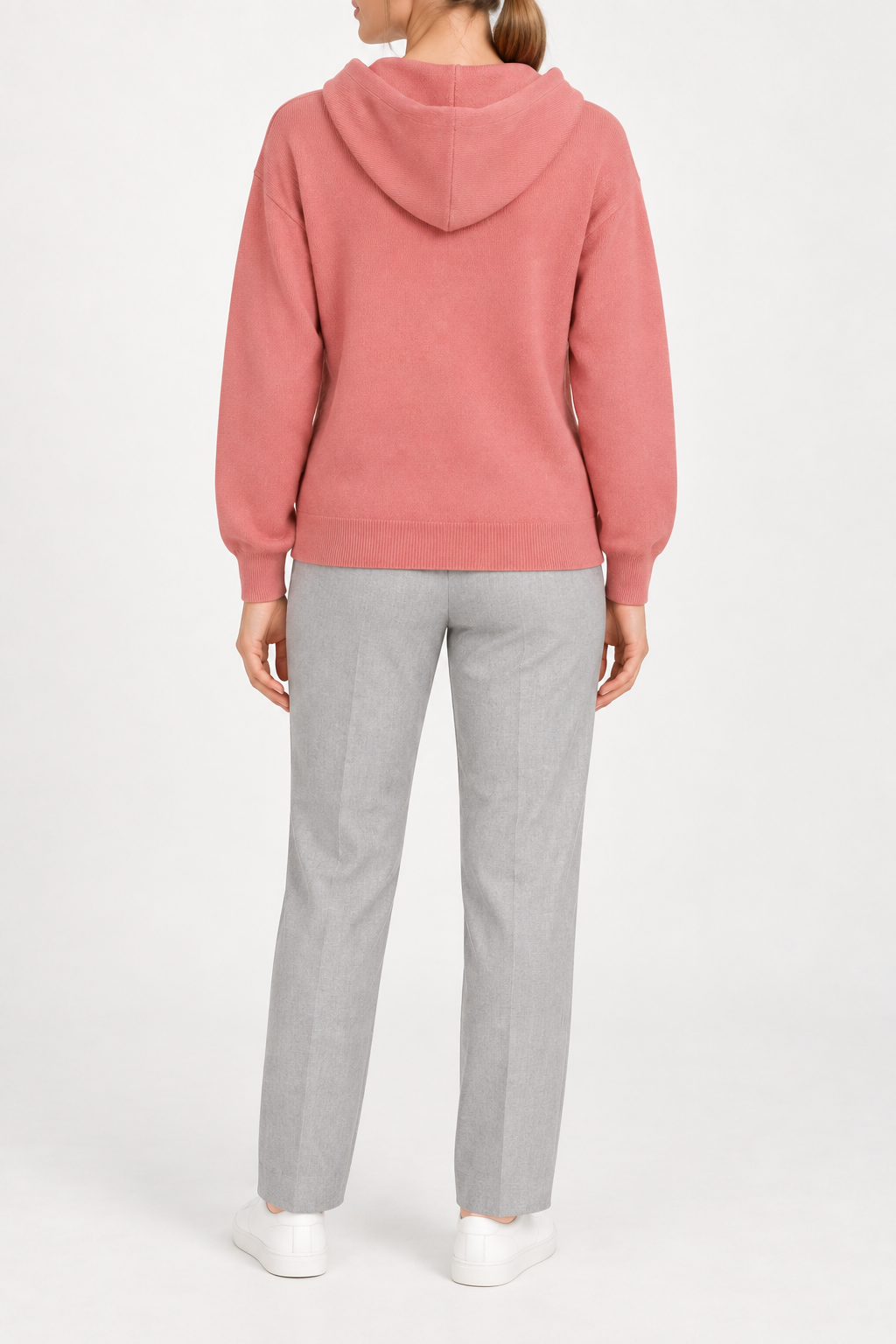 Rear view showing the plain coral back and draped hood of Quiet Ease Knit Hoodie in Coral.