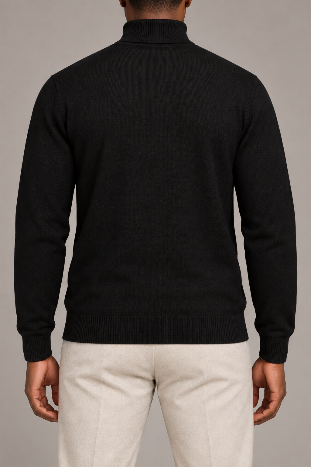 Rear view showing the plain Black back and high collar of Still Season Turtleneck Sweater in Black.