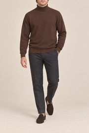 Walking view showing the Soil brown knit drape and long sleeves of Still Season Turtleneck Sweater in Soil.