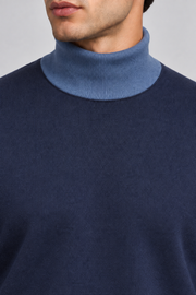 Close-up showing the Denim turtle collar against the Navy knit of Still Season Turtleneck in Navy with Denim Trim.