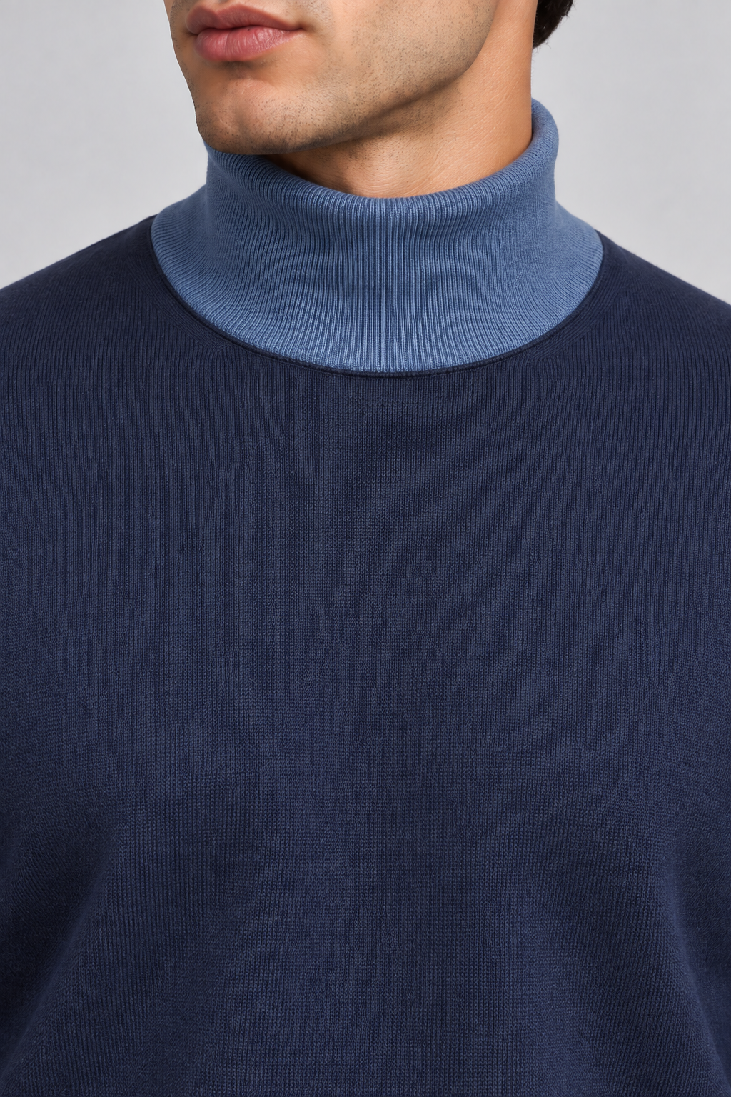 Close-up showing the Denim turtle collar against the Navy knit of Still Season Turtleneck in Navy with Denim Trim.