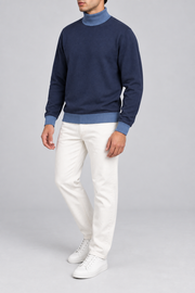 Three-quarter view showing the Navy silhouette and Denim hem of Still Season Turtleneck in Navy with Denim Trim.