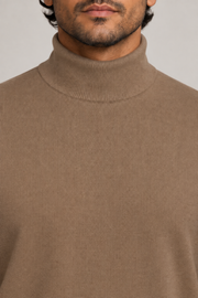 Close-up showing the Peanut turtle collar and fine knit texture of Still Season Turtleneck Sweater in Peanut.