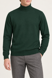 Hero front showing the plain Pine green knit and high collar of Still Season Turtleneck Sweater in Pine.