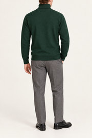 Rear view showing the plain Pine green back and ribbed hem of Still Season Turtleneck Sweater in Pine.