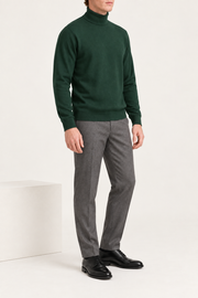 Three-quarter view showing the Pine green silhouette and matching edges of Still Season Turtleneck Sweater in Pine.