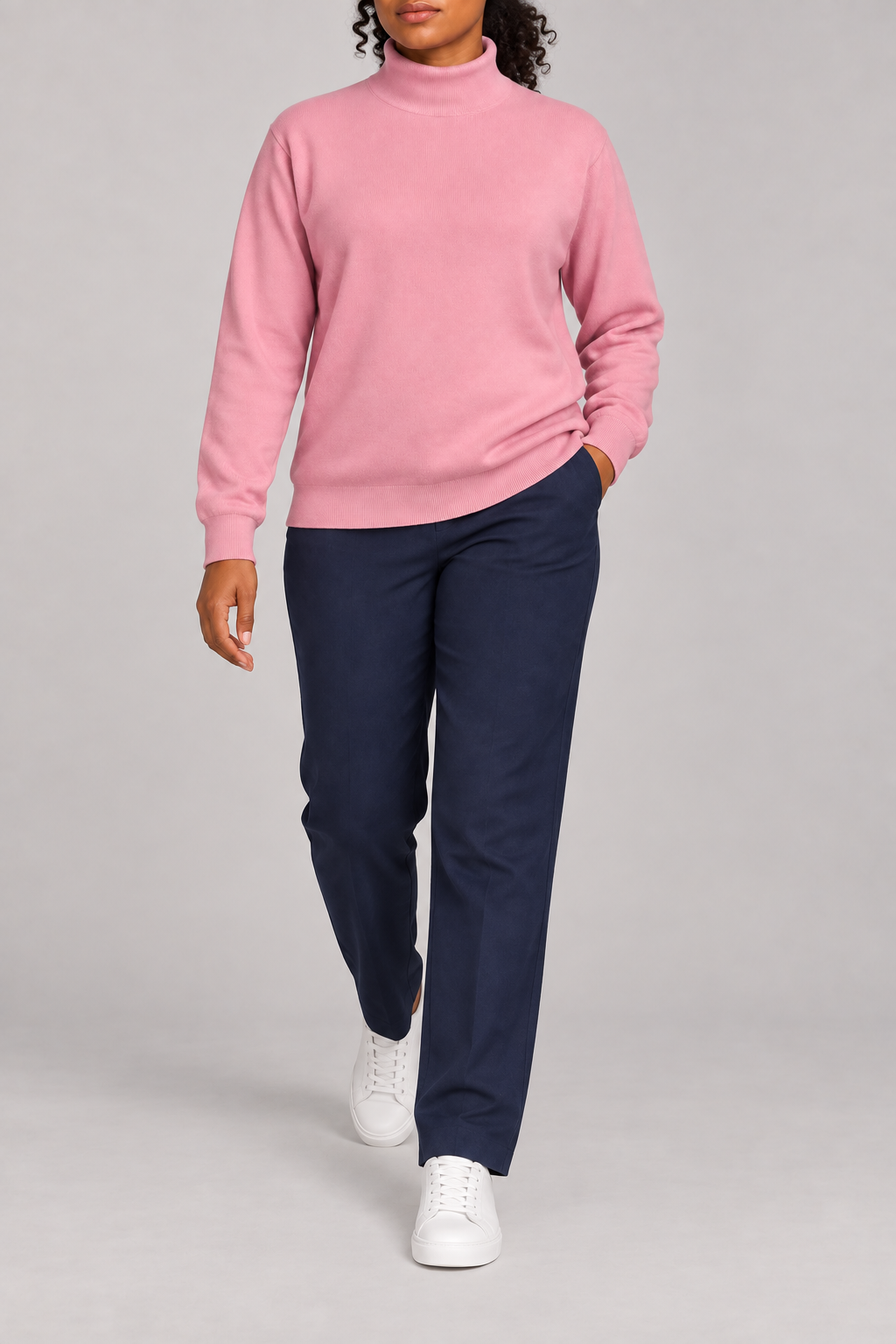 Walking view showing the Pink knit drape and long sleeves of Soft Horizon Turtleneck Sweater in Pink.